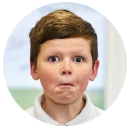 A young boy pulling a funny face, suggesting that something went wrong